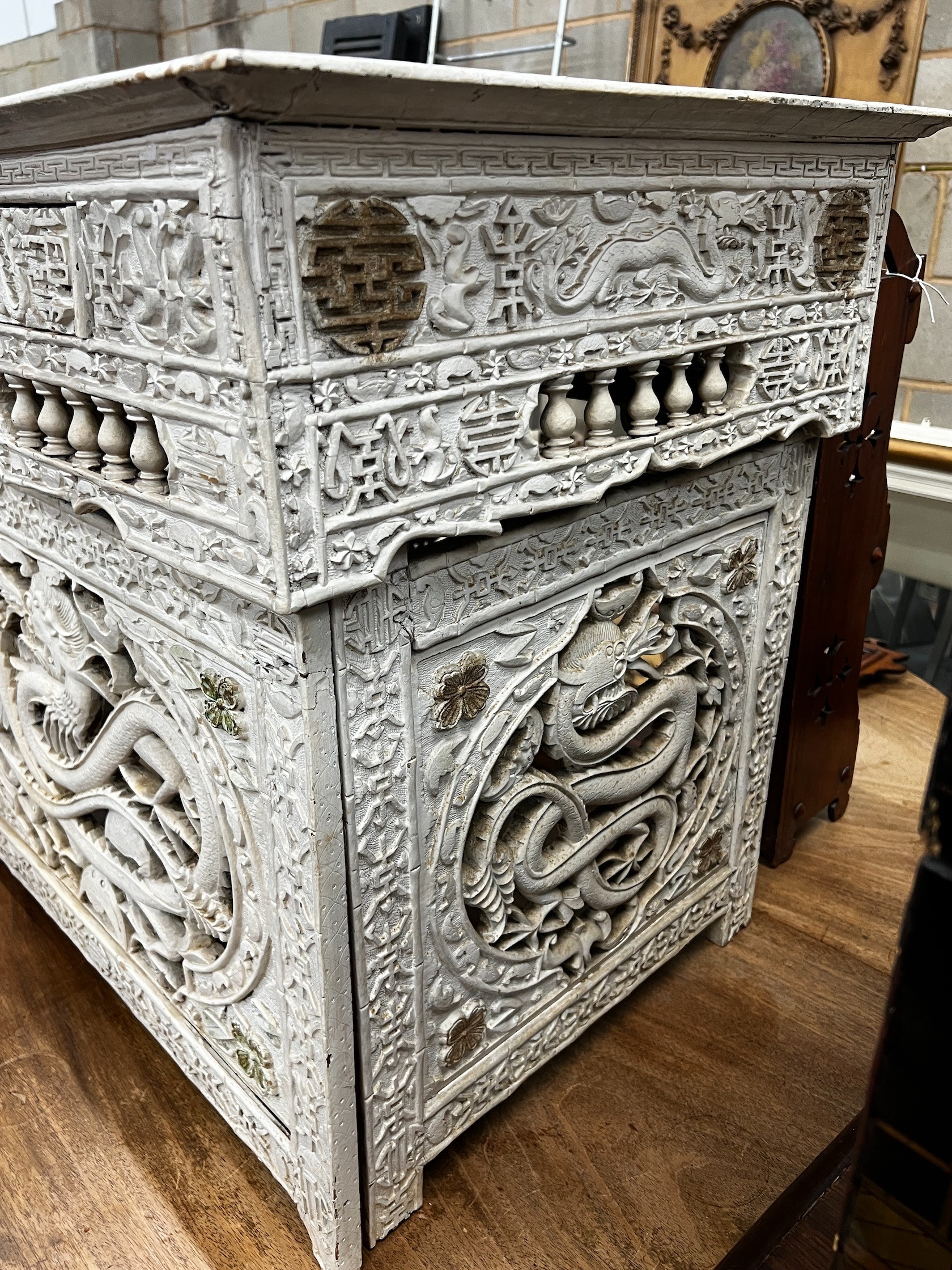 An early 20th century Chinese carved side table, width 75cm depth 56cm height 67cm (later painted)